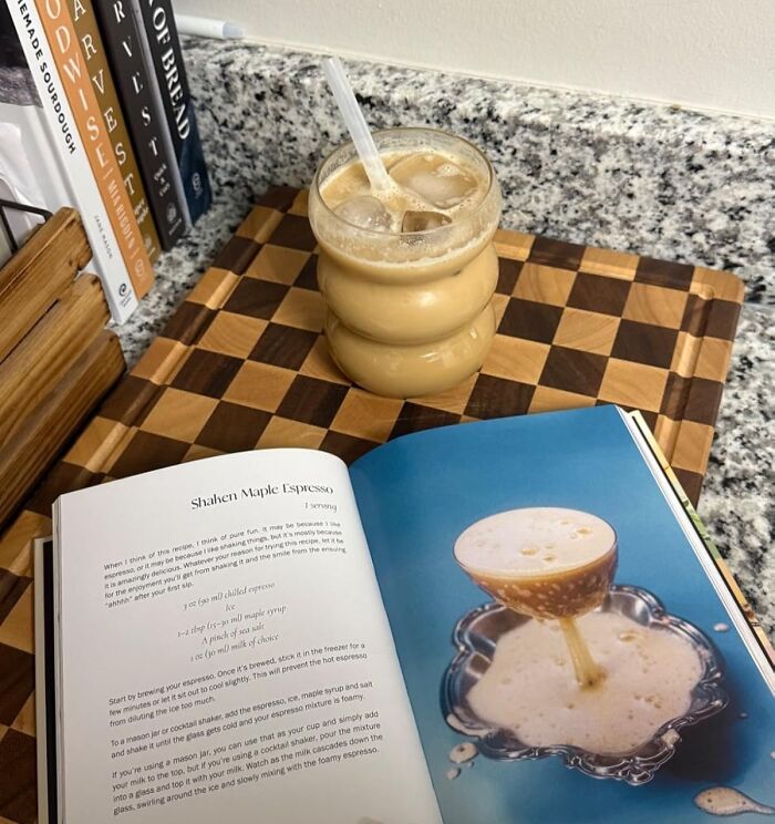 Iced coffee drink with recipe book and cookbooks on countertop, perfect last minute Mother's Day gift ideas
