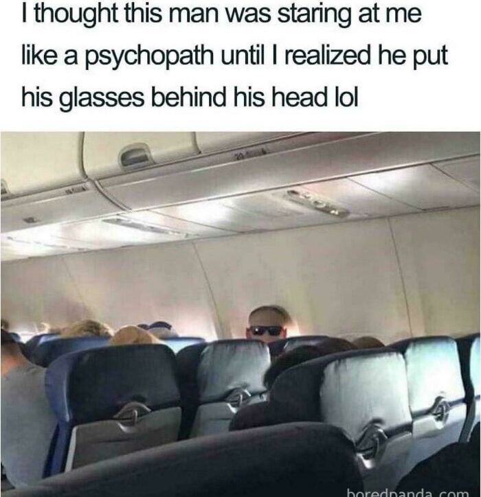 Man on an airplane appearing to stare intensely but actually wearing glasses behind his head anxiety memes relatable humor