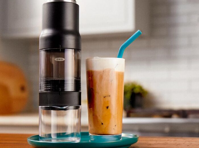 Portable coffee grinder and iced coffee on a teal tray, perfect last minute Mother's Day gifts idea.