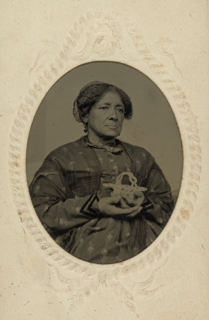 Vintage portrait of a strong African American woman over a century ago, representing resilience and strength in history.