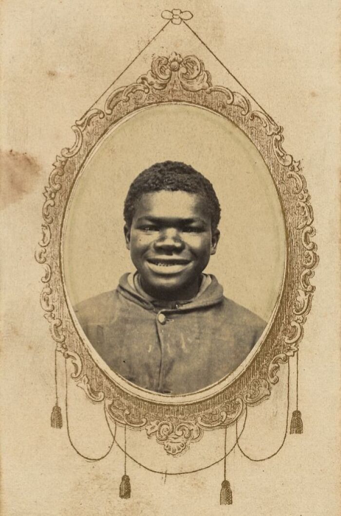Portrait of a smiling African American boy from over a century ago, highlighting the strength of African Americans.