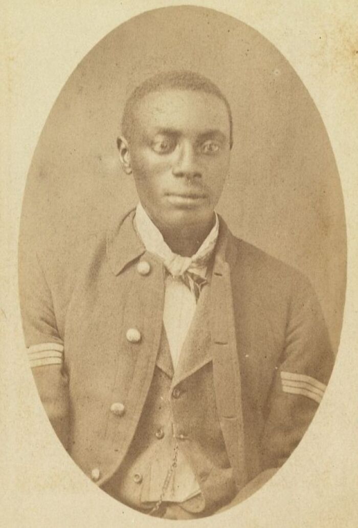 Portrait of a strong African American man dressed in 19th-century attire showing resilience over a century ago.