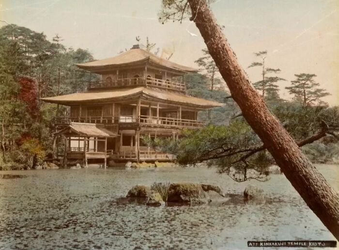 Historic wooden temple by a pond surrounded by trees, showing what Japan looked like in the 1800s.