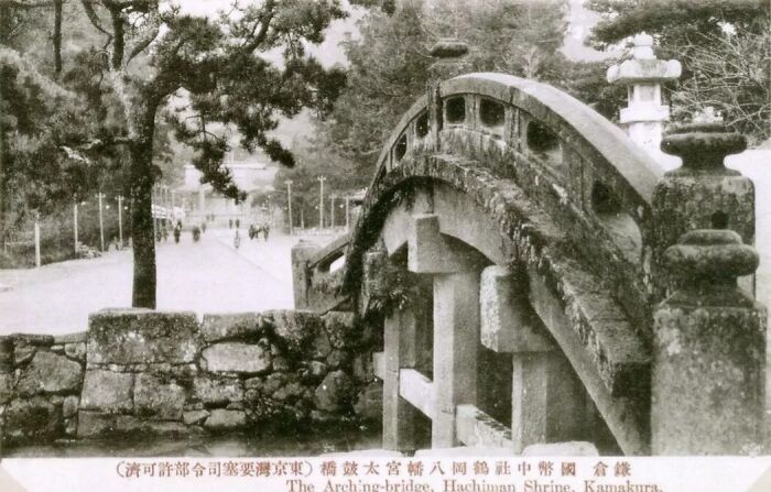 Stone bridge and pathway surrounded by trees in historical Japan, depicting scenes from the 1800s era.