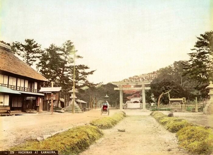 Old Japan street scene with traditional houses and a torii gate, showcasing Japan in the 1800s.