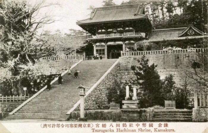 Old black and white image of Tsurugaoka Hachiman Shrine in Japan showing traditional architecture and steps in the 1800s.