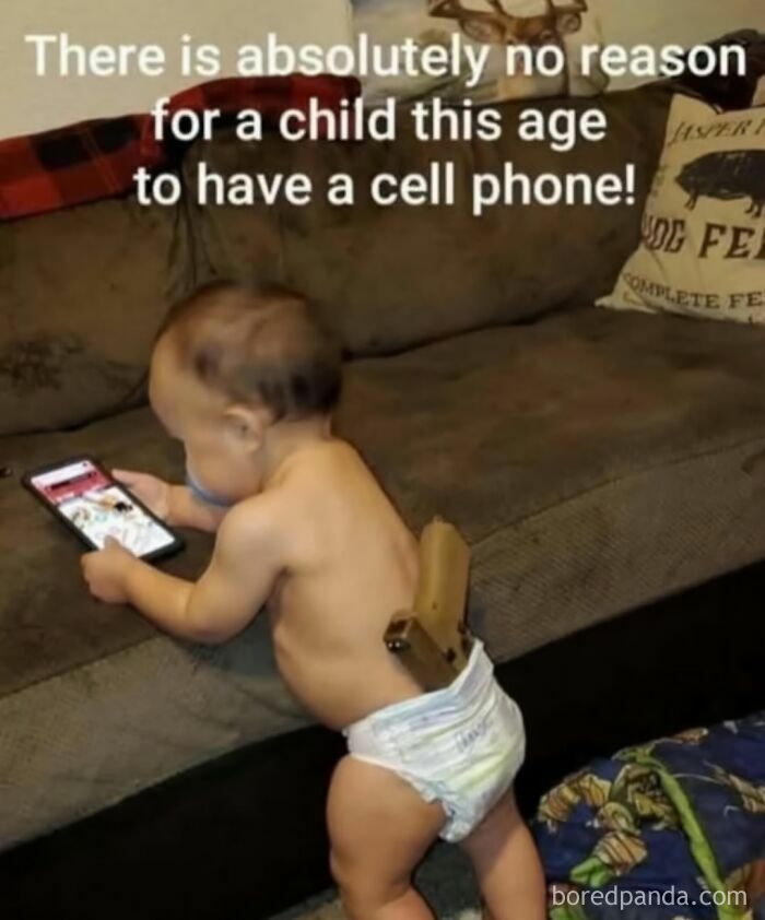 Baby in a diaper holding a cell phone on a couch illustrating funny and random shower thoughts humor.