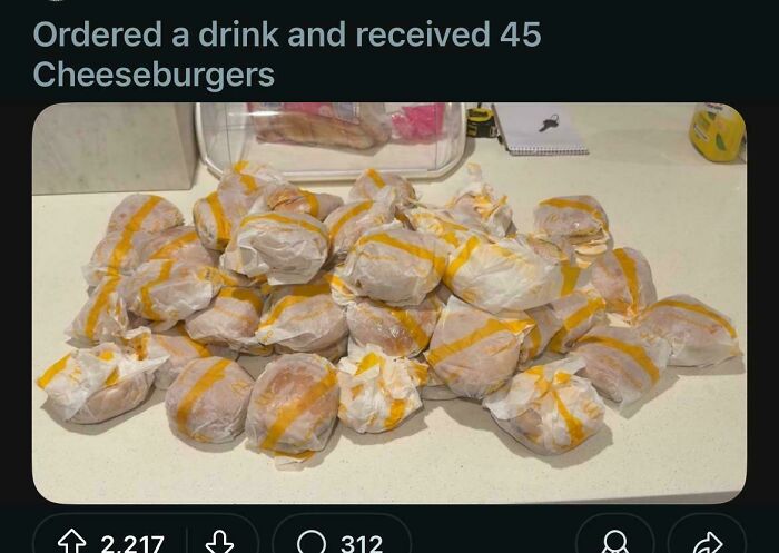 A large pile of 45 wrapped cheeseburgers on a table, illustrating outrageous lies people tried to pass off as real.