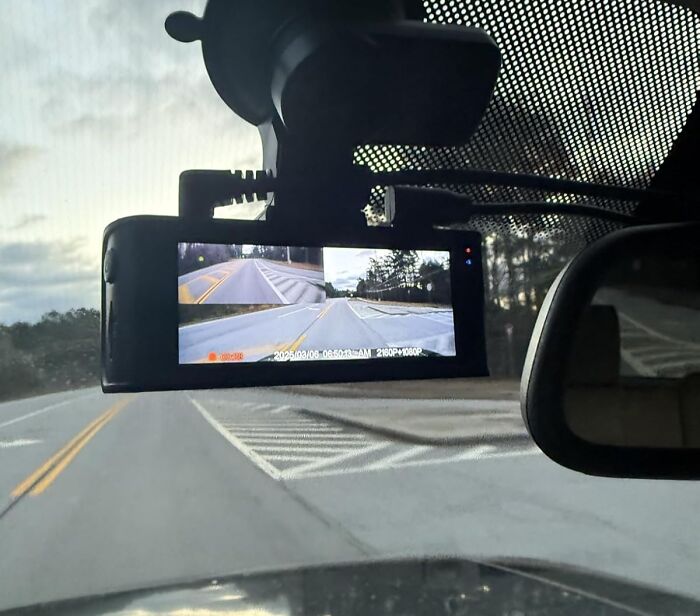 Car dashcam mounted on windshield showing multi-angle road views for practical car advice on safe driving tips