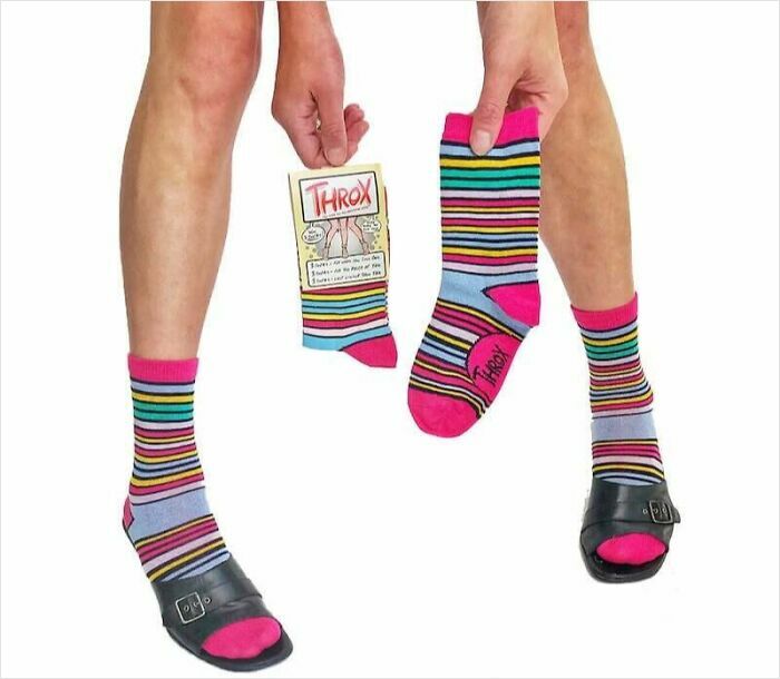 Person wearing and holding colorful striped Throx socks with black sandals, representing a Shark Tank product flop.
