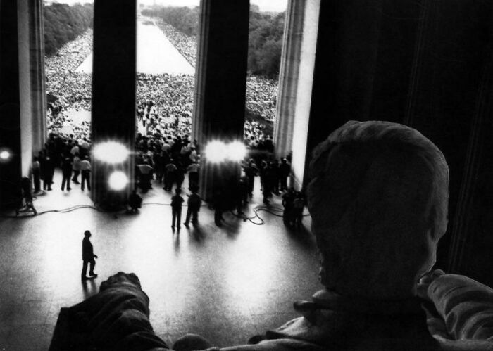 View from Lincoln Memorial statue showing alternate angle of iconic historical event with large crowd at the National Mall.