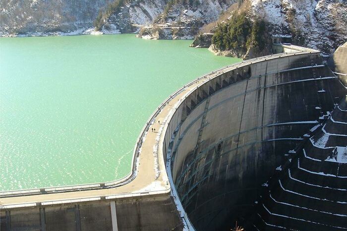 Aerial view of a large dam and reservoir, showcasing an alternate angle of an iconic historical engineering landmark.