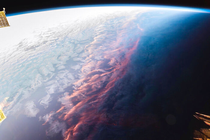 View of Earth from space showing clouds and atmospheric layers, a unique alternate angle of an iconic event.