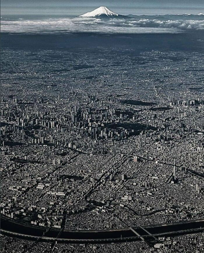 Aerial view of Tokyo cityscape with Mount Fuji in the background, showing an alternate angle of an iconic place in history.