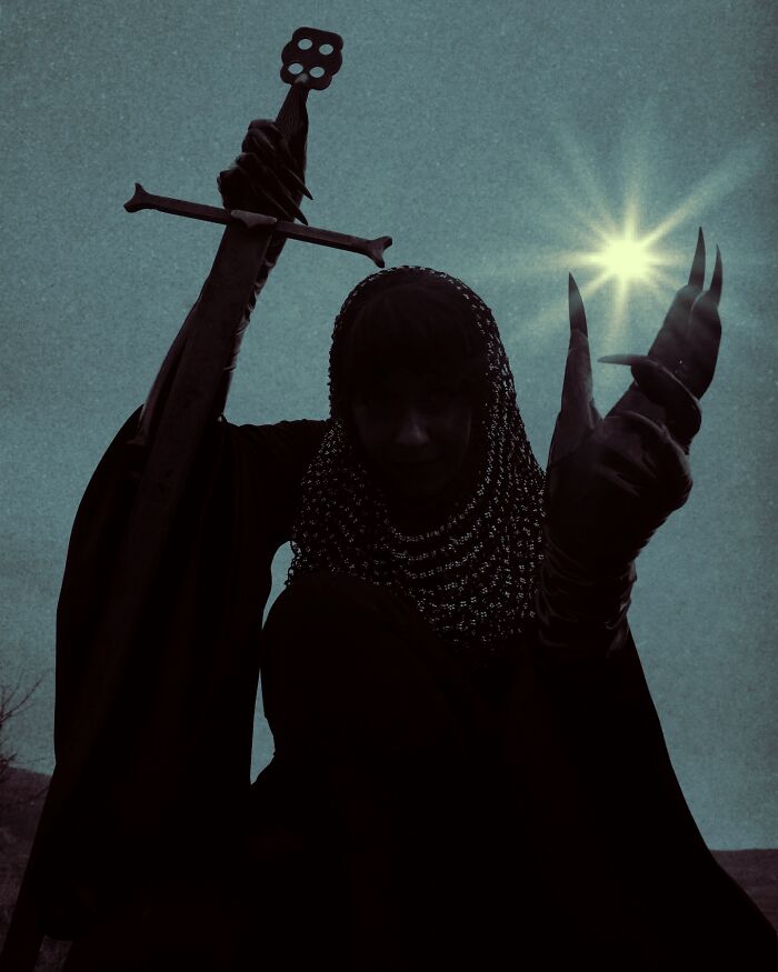 Dark escapism photography featuring a cloaked figure with a sword and claws against a moody sky with a bright star.