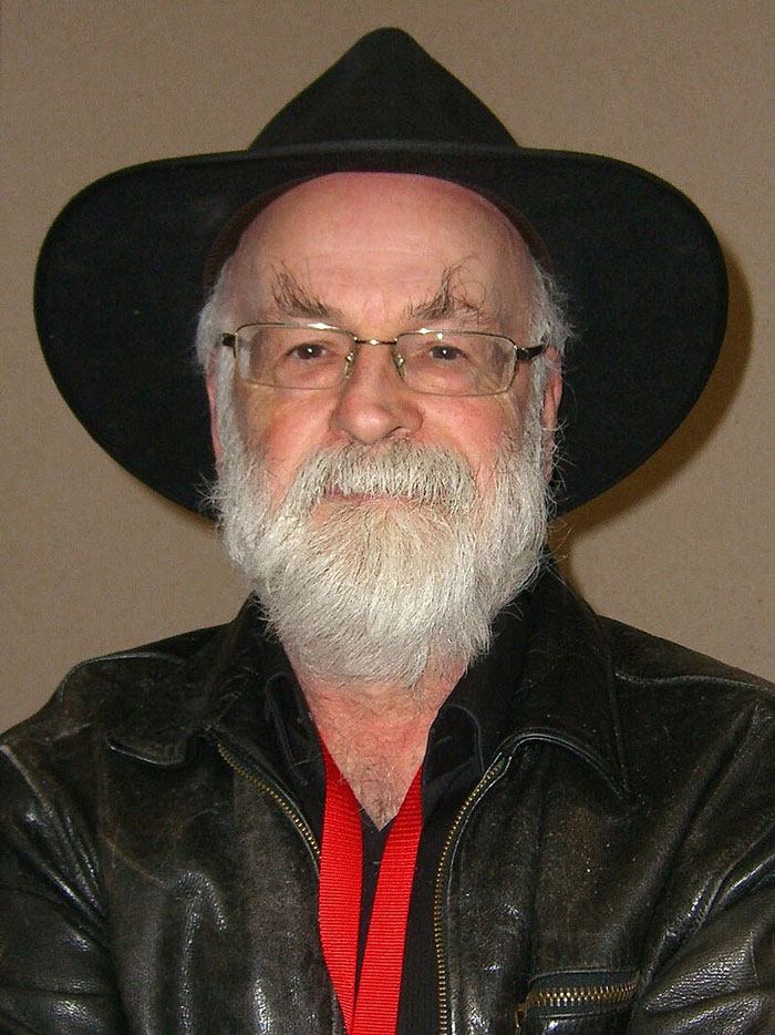 Bearded man in hat and glasses, wearing a leather jacket, representing beloved stars in a wholesome context.