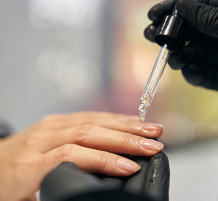 Nail care with oil dropper on hand, linked to Gen Z viral debate on patriarchy and short-nail theory. Nail care with oil dropper on hand, linked to Gen Z viral debate on patriarchy and short-nail theory.