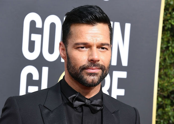 Man in a black suit and bow tie at an event, representing true rumors theme.