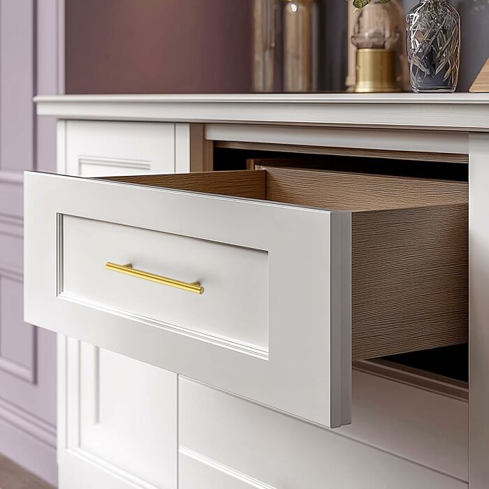 White dresser with an open drawer and gold handle, showcasing affordable furniture from a popular Amazon haul.