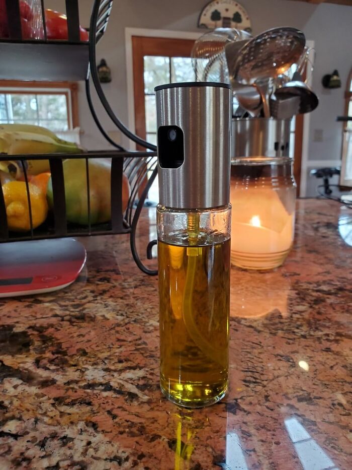 Spray bottle filled with cooking oil on kitchen counter, part of Amazon haul kitchen deals for budget-friendly cooking essentials.