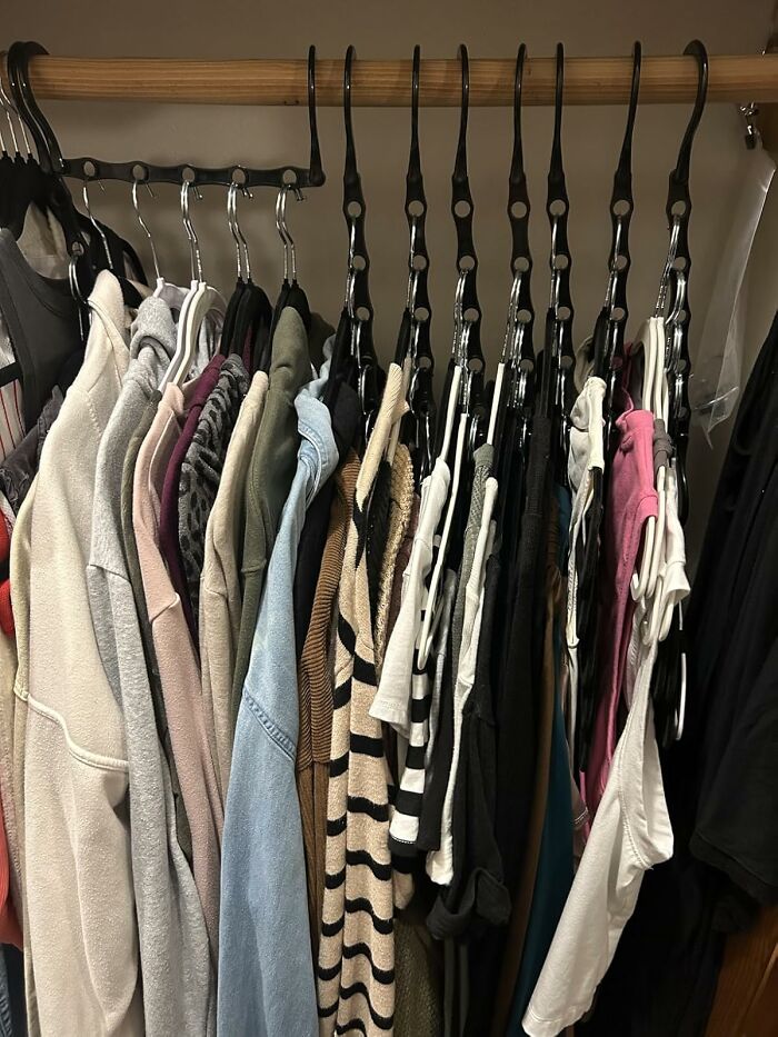 Closet rack with organized clothing on hangers showcasing casual outfits for a Wednesday style that might not totally suck.