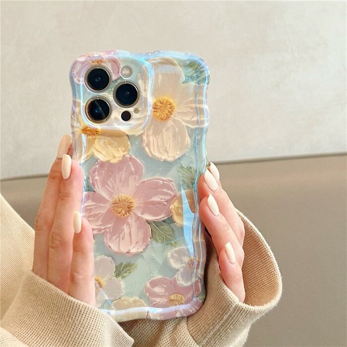 Hand holding iPhone with floral protective case, a stylish Amazon haul find trending in phone accessories.