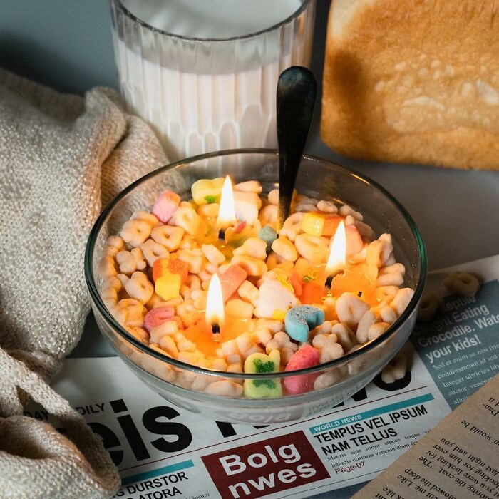 Cereal bowl with candles, milk, toast, and newspaper; trendsetting treasures for your table.