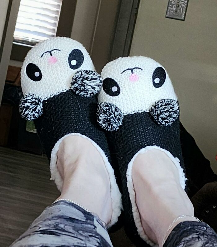Panda-themed slippers on feet, showcasing cozy and playful designs.