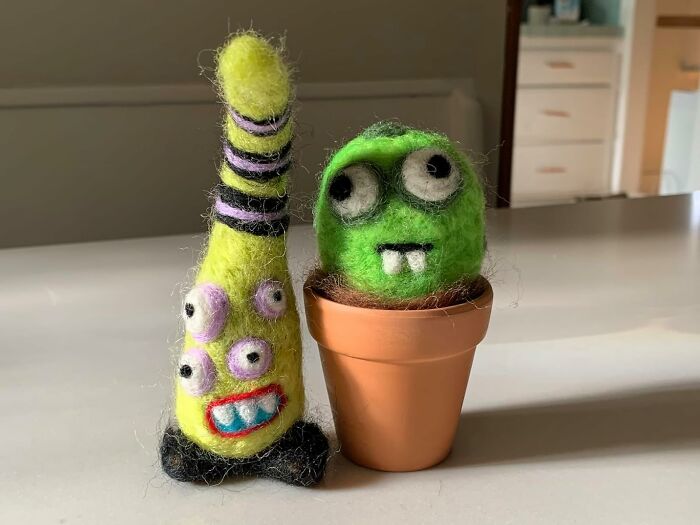 Colorful felt creatures, one in a pot, with quirky eyes and vibrant designs, embodying dream in color aesthetics.