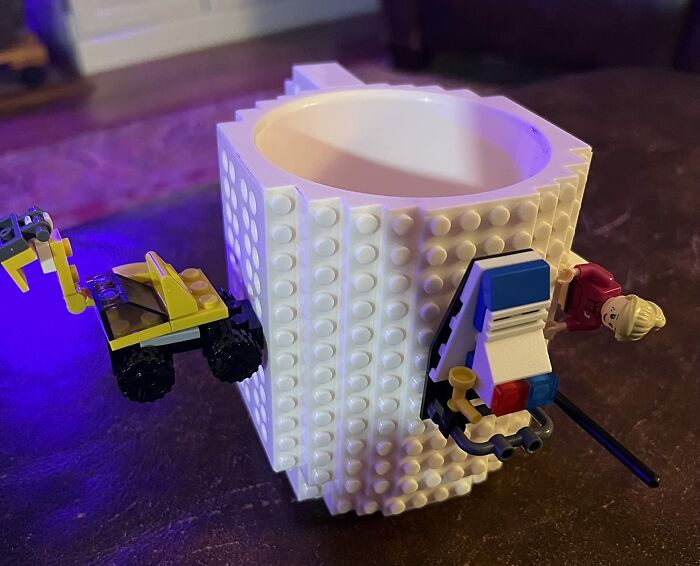Lego-themed mug with miniature work supplies attached for a playful desk accessory.