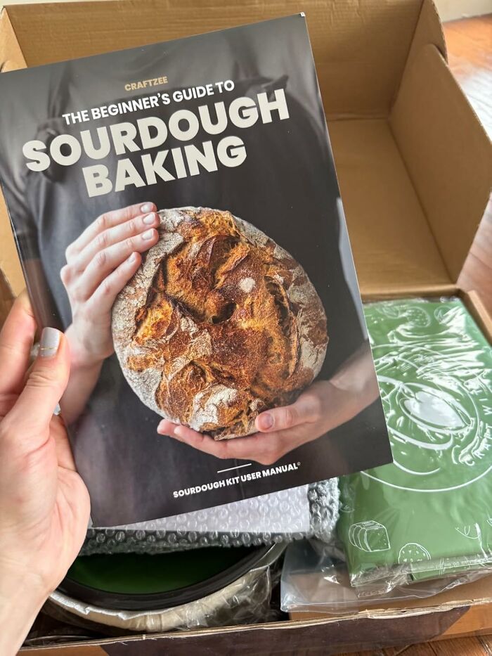 Beginner's guide to sourdough baking kit held over an open box with baking supplies inside, ideal Mother's Day gifts.