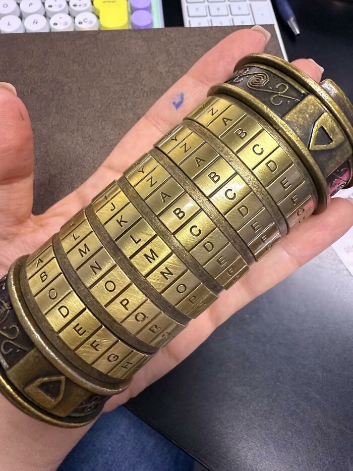 Hand holding a vintage brass cipher lock puzzle, one of the unique Amazon finds blending genius and curiosity.