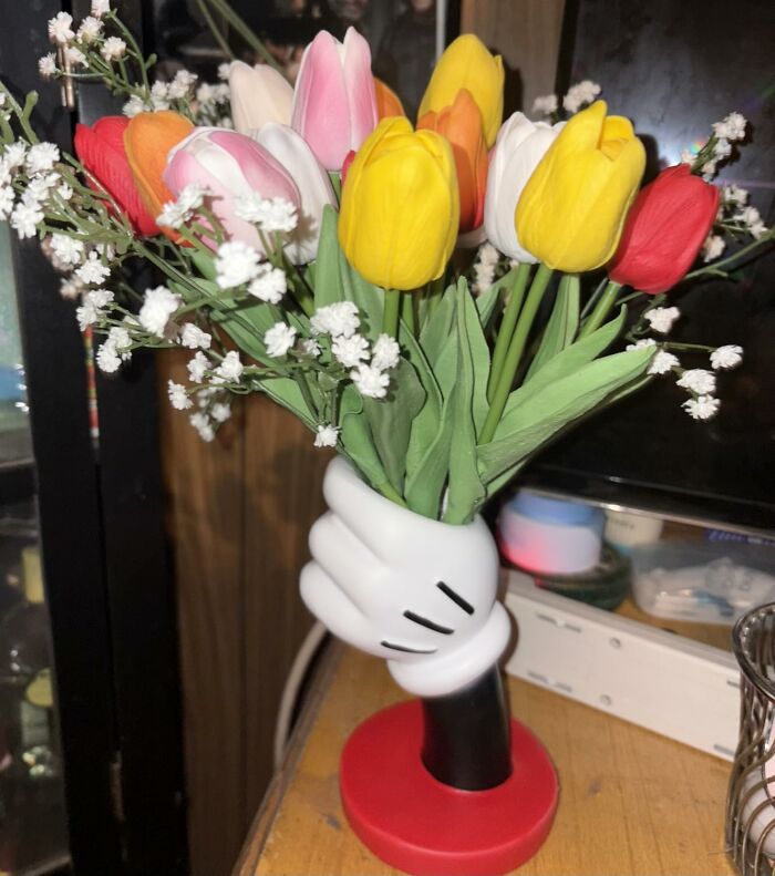 Colorful tulip bouquet in a unique hand-shaped vase, a creative Mother's Day gift idea to impress and delight.