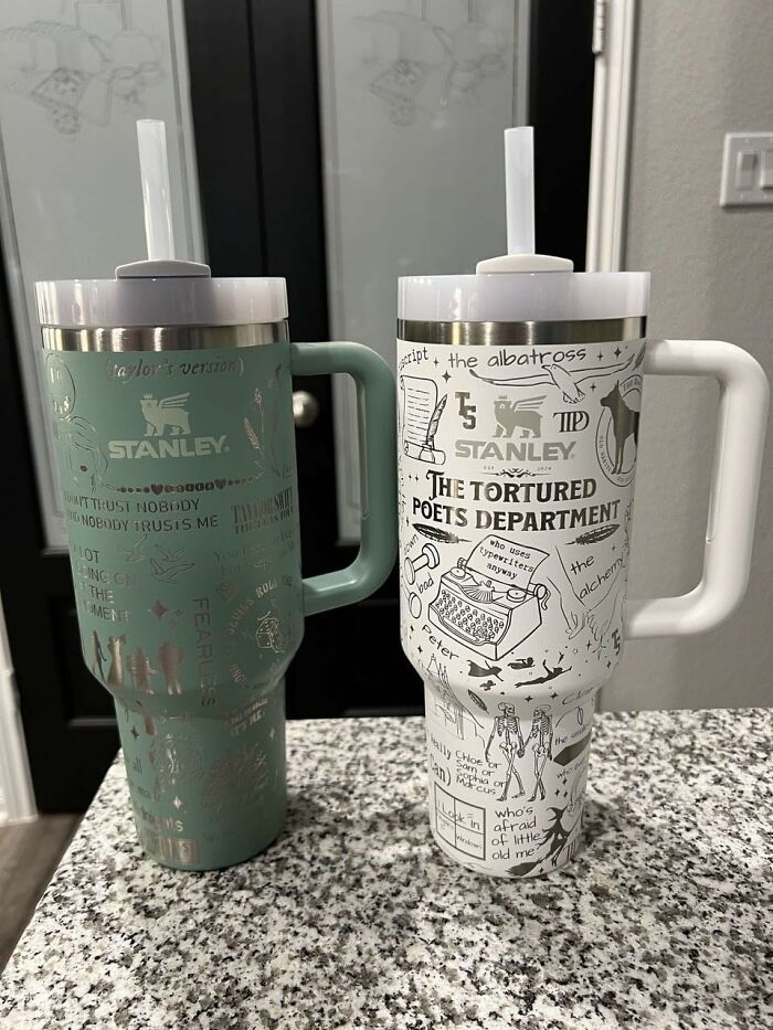 Two Stanley mugs with creative designs placed on a granite countertop, capturing millennial style appeal.