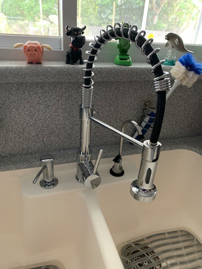 Smart home kitchen sink faucet with a coiled design, surrounded by fun animal figurines.