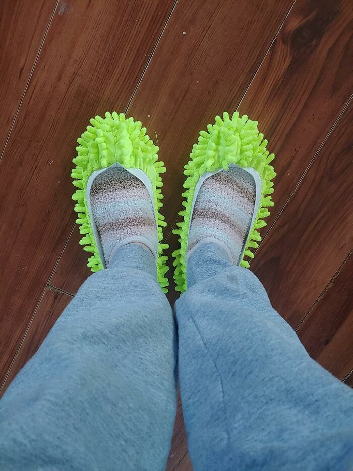 Green microfiber mop slippers worn on wooden floor, perfect household product for daily cleaning.