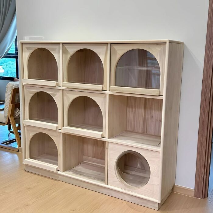 Custom woodworking ideas cabinet with multiple compartments featuring arched and circular cutouts in light wood finish.