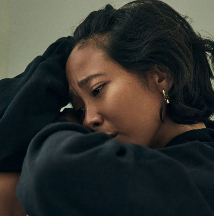 Woman looking emotional and introspective, reacting to a sugar daddy's surprising marriage proposal.