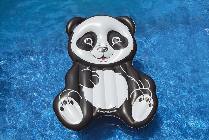 Panda-shaped pool float on blue water.