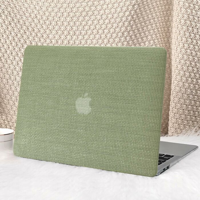 Green textured laptop cover on a MacBook, set against a woven backdrop, showcasing show-stopping style.