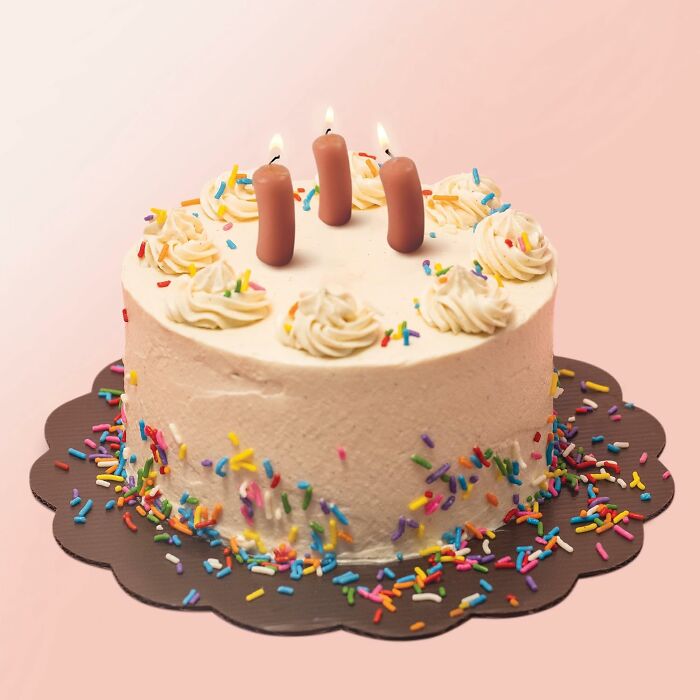 Whimsical wax masterpiece: birthday cake with sausage candles and colorful sprinkles.