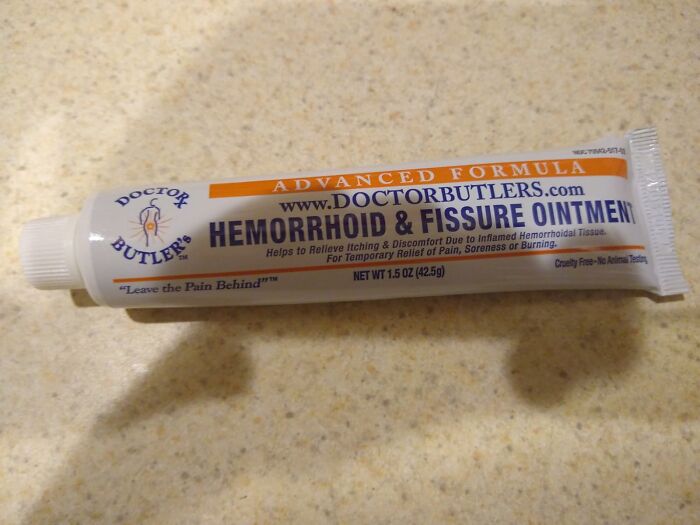 Tube of hemorrhoid and fissure ointment placed on a countertop.