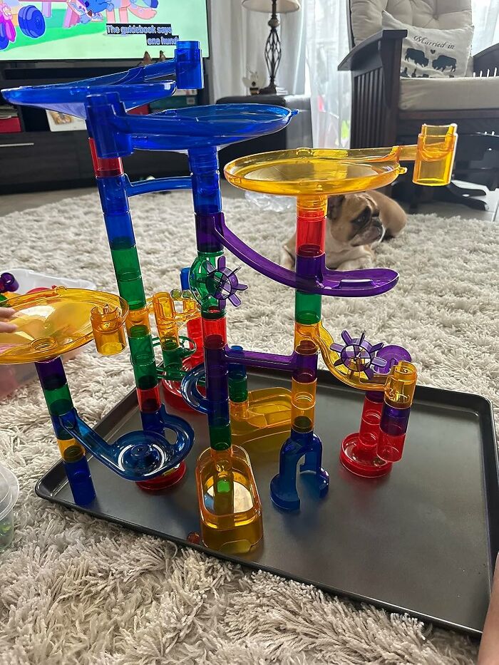 Colorful marble run toy set assembled on a tray on carpet, showcasing popular toys kids genuinely can't get enough of.