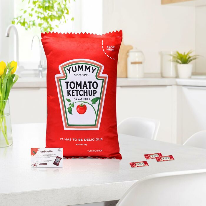 Large ketchup packet decor on a kitchen table, adding quirky charm to a generic apartment.