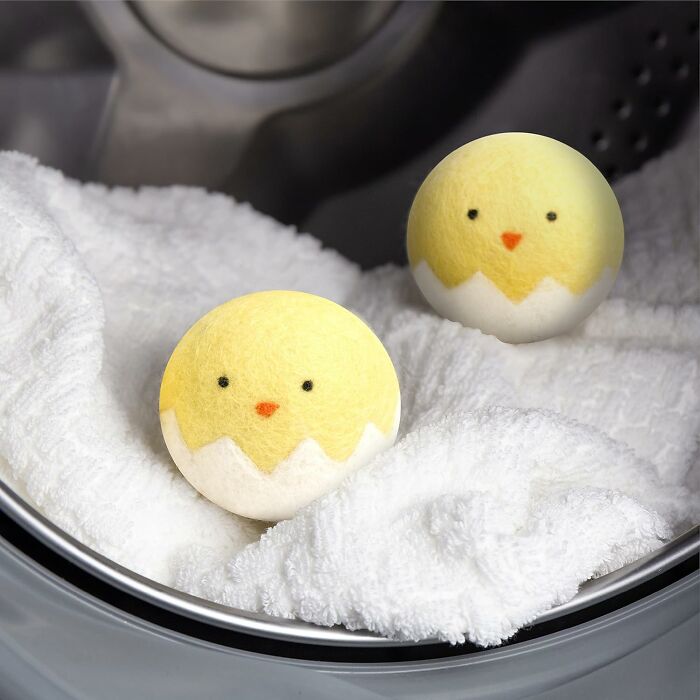 Cute chick dryer balls on white towels, unique gift idea for friends.