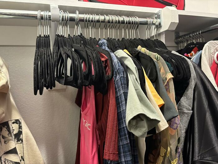 Amazon product selection hanging on black velvet hangers in a closet.