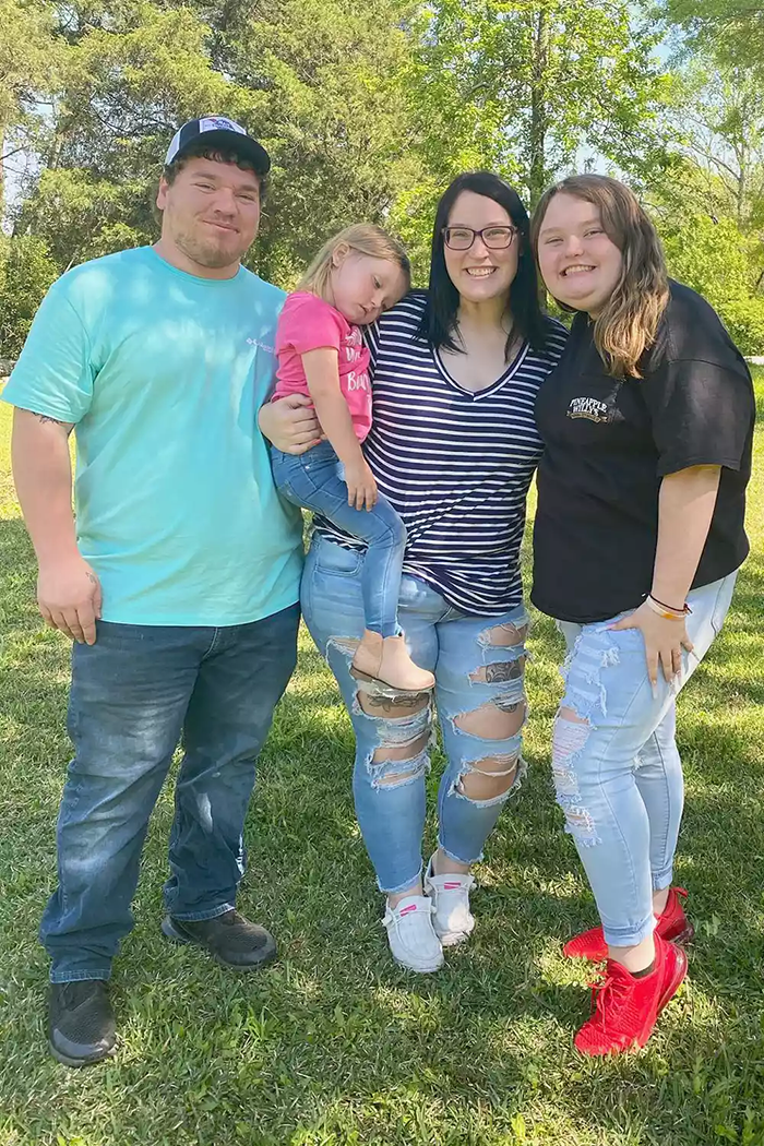 Family posing outdoors in casual attire on a sunny day, related to Honey Boo Boo's turbulent life.