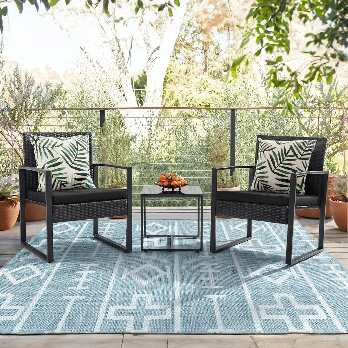 Outdoor patio set with chairs and table on blue patterned rug, among most-wished-for items on Amazon.