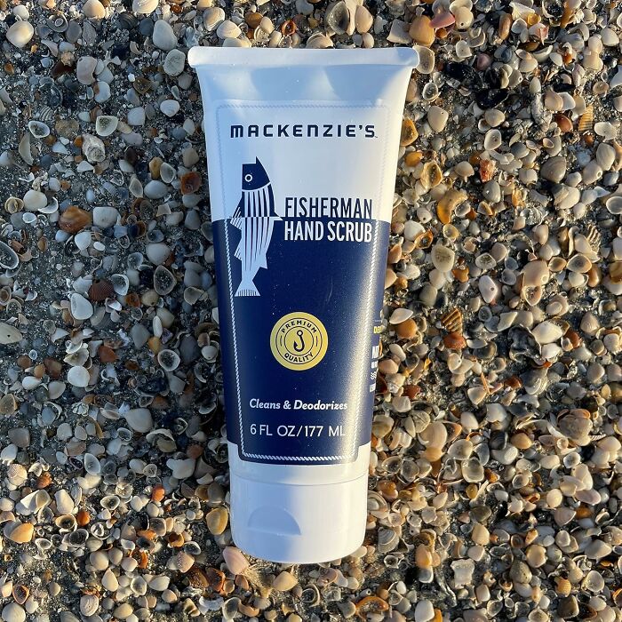 Fisherman hand scrub tube on shell-covered beach, perfect unique gift.