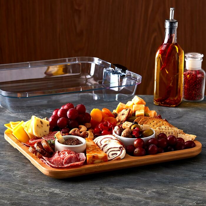 Charcuterie board with cheese, grapes, nuts, and meats. Perfect gift idea beyond a 'World's Okayest Friend' mug.